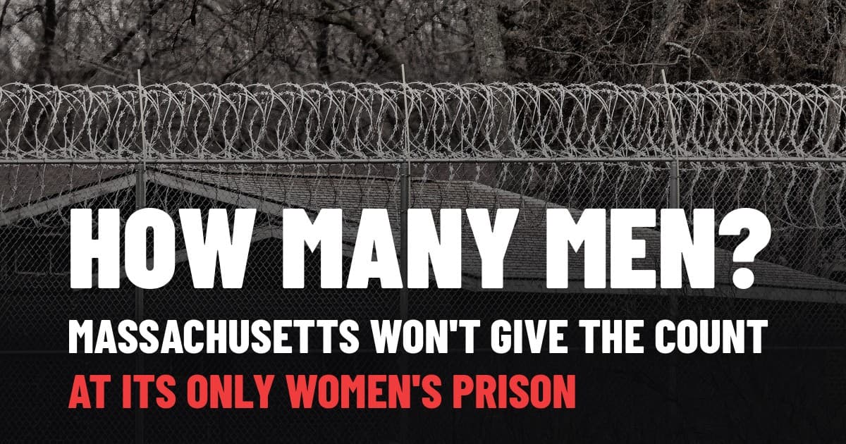 Razor wire and chain-link fence around a prison building